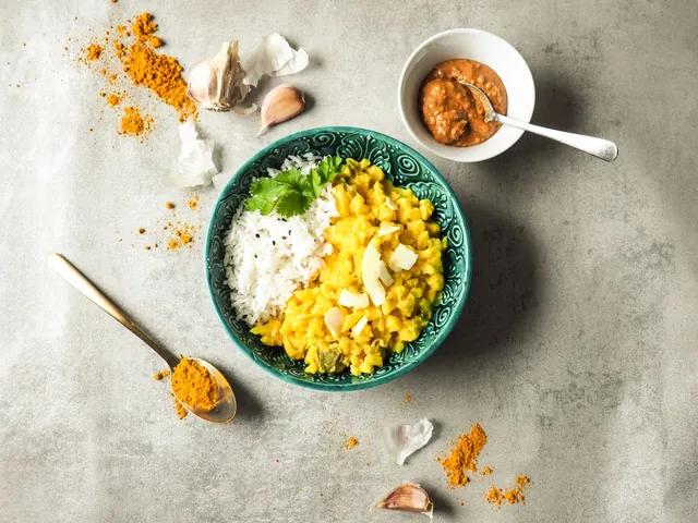 A bowl of cauliflower in coconut sauce with rice and turmeric